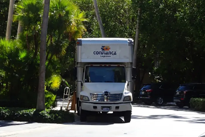Front of a Confiança Logistics moving truck on a residential street